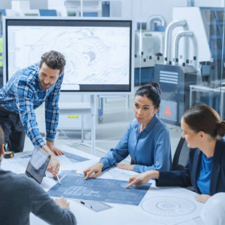 Modern Factory Office Meeting Room: Busy Diverse Team of Engineers, Managers and Investors Talking at Conference Table, Use Interactive TV, Analyze, Find Solutions, Debate and Discuss Engine Concept